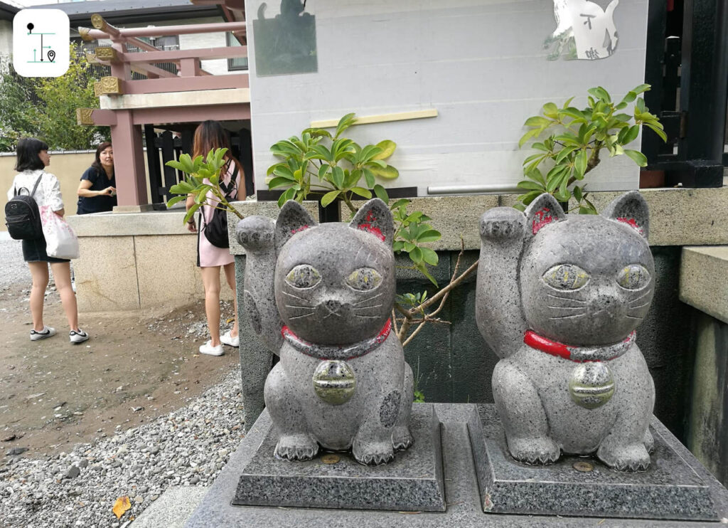 double huge stone cats inside the cat temple in Tokyo