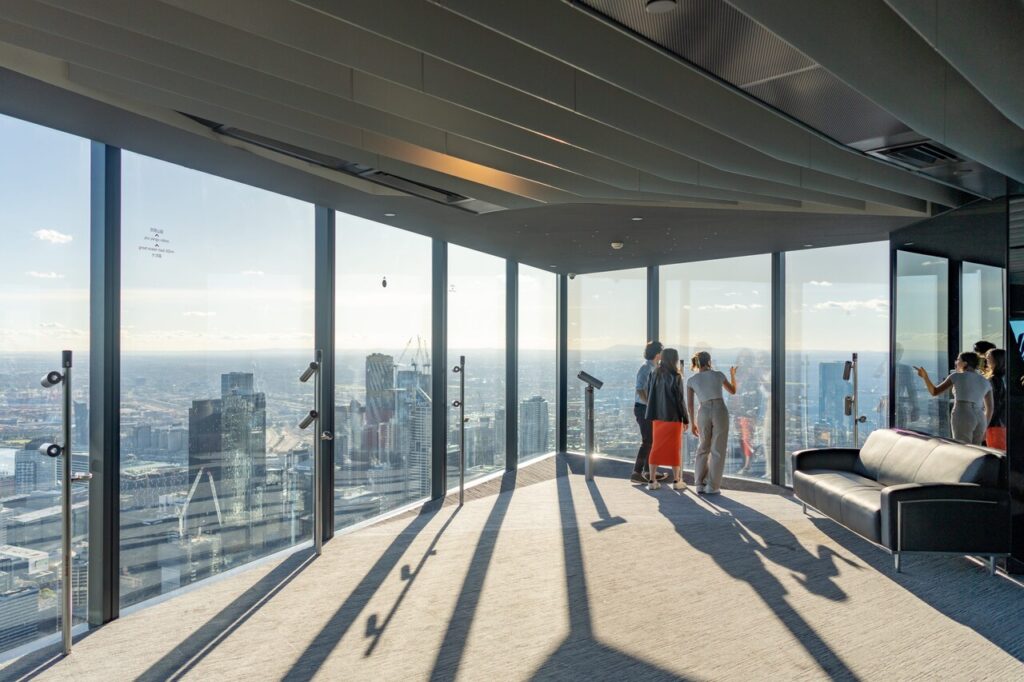 the visitors are checkingout the skyline in the observation deck in the Melbourne Skydeck.