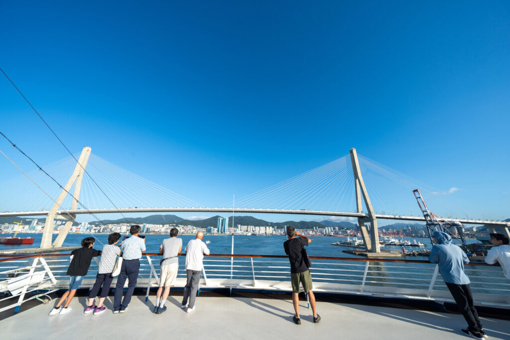 People standing on the Deck of Peace Boat Pacific World Cruise