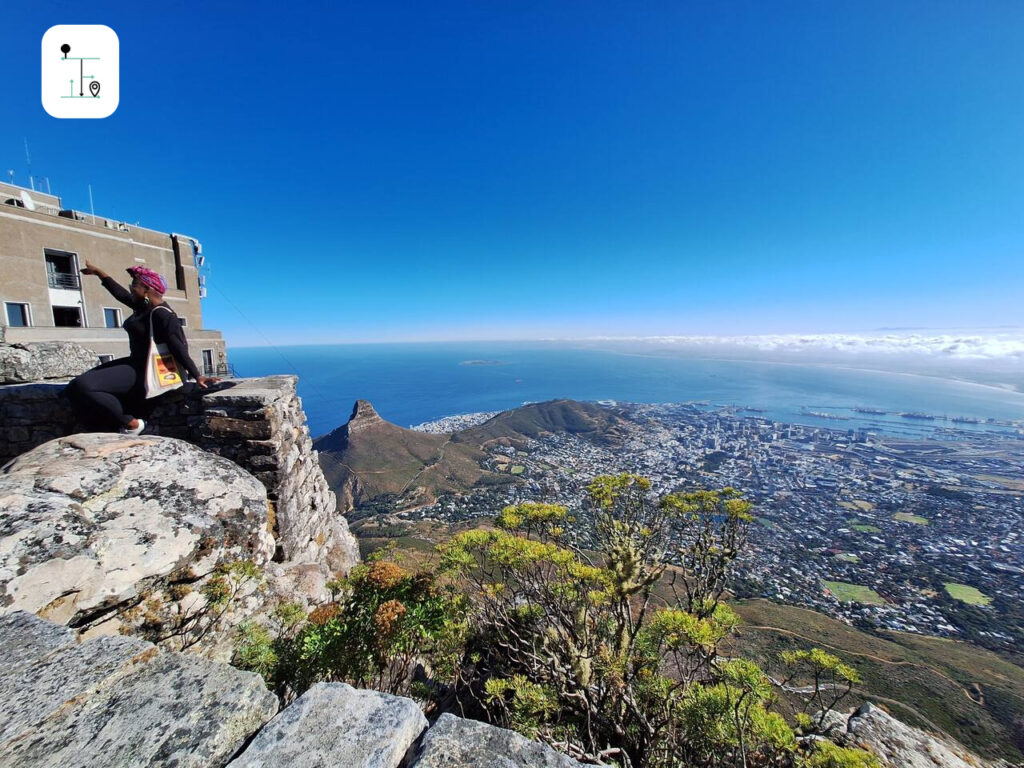 A lady do film shooting with the clear Cape Town view.