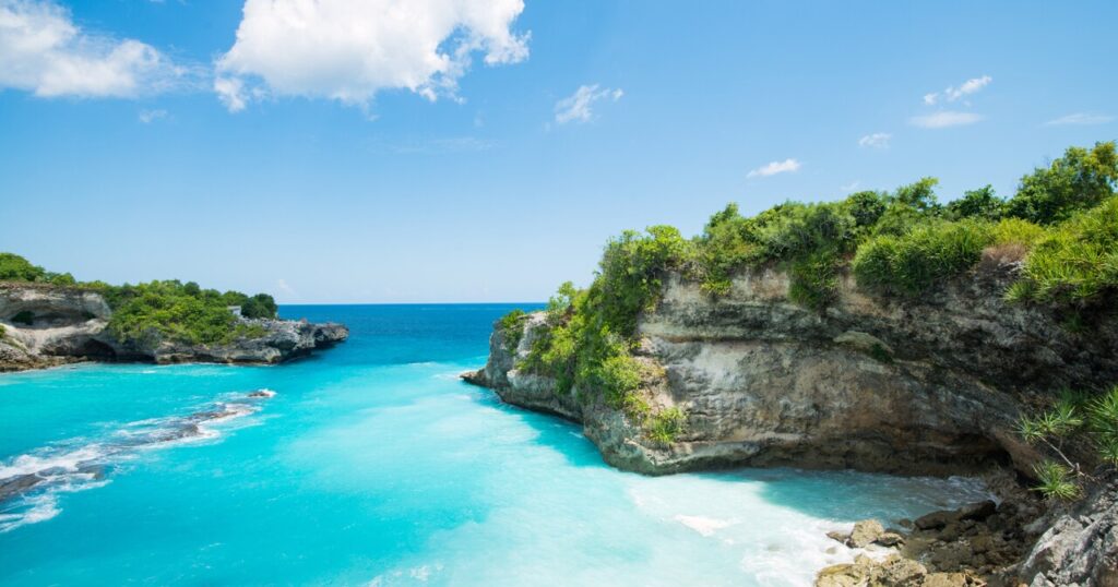 New destination for direct flight HK to Bali by AirAsia. Beautiful cliff with skyblue sea in Bali.