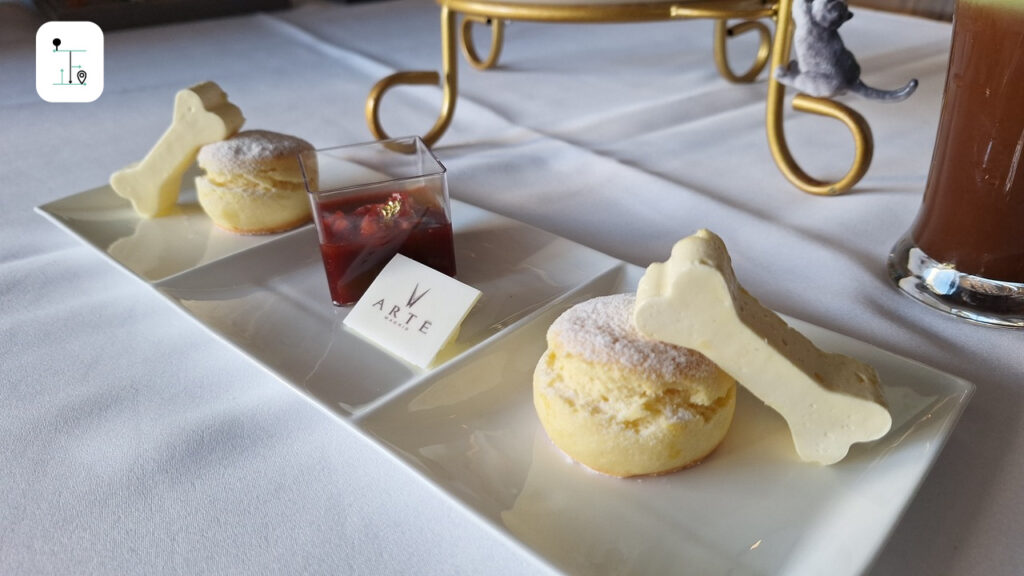 Scones on tea set with a dog bone shaped butter.